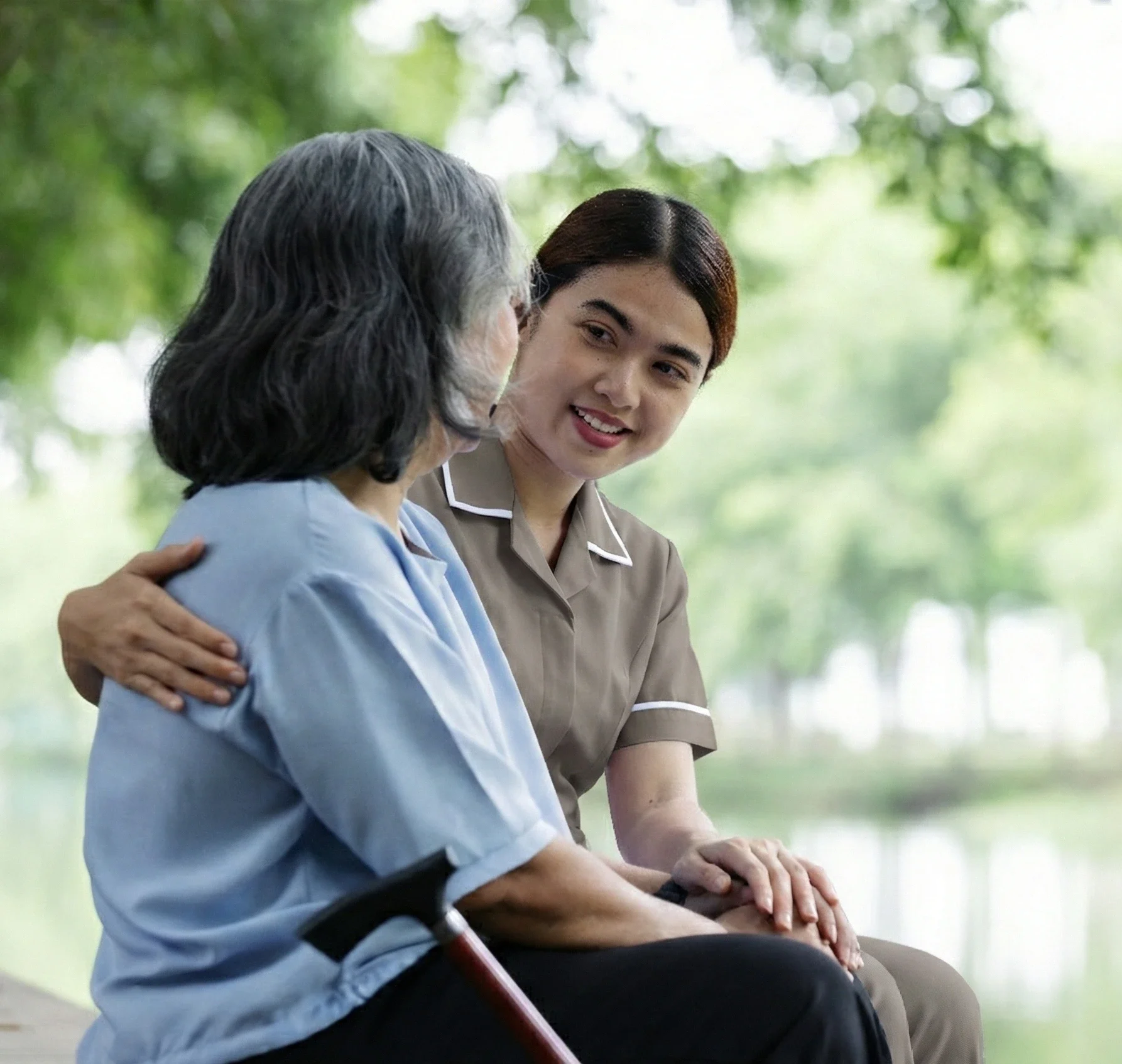 SD Care carer sitting quietly with an elderly client at home, providing compassionate palliative support